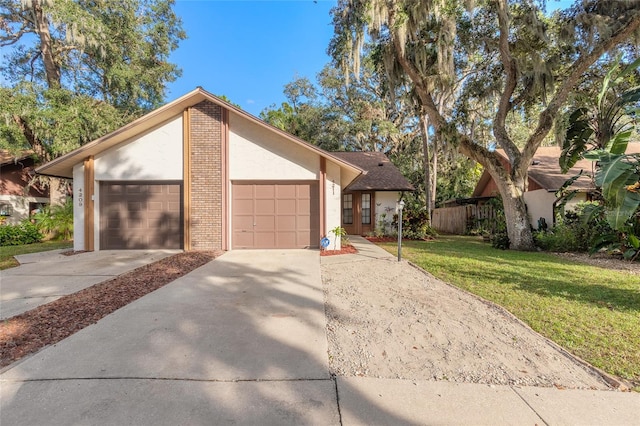 ranch-style home with a garage and a front yard