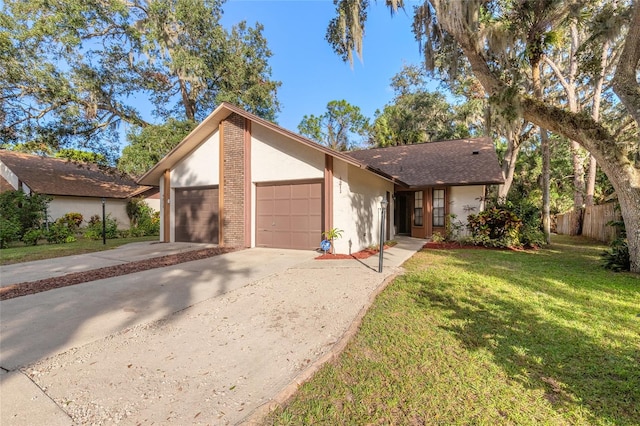 ranch-style home with a garage and a front lawn