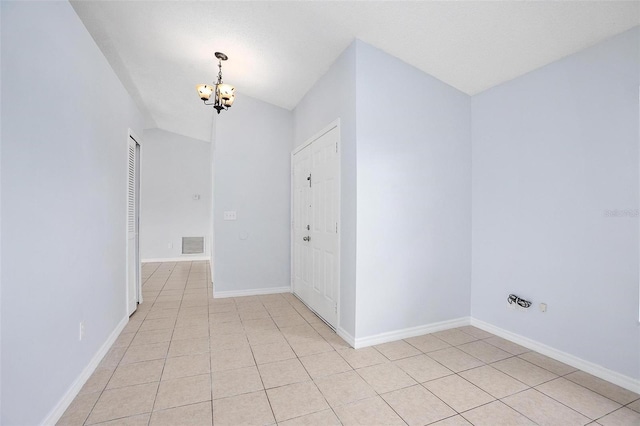 interior space featuring lofted ceiling and a chandelier