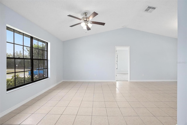 unfurnished room with ceiling fan, light tile patterned floors, and lofted ceiling