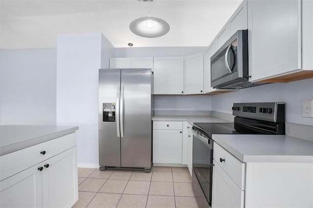 kitchen with white cabinets, light tile patterned floors, and stainless steel appliances