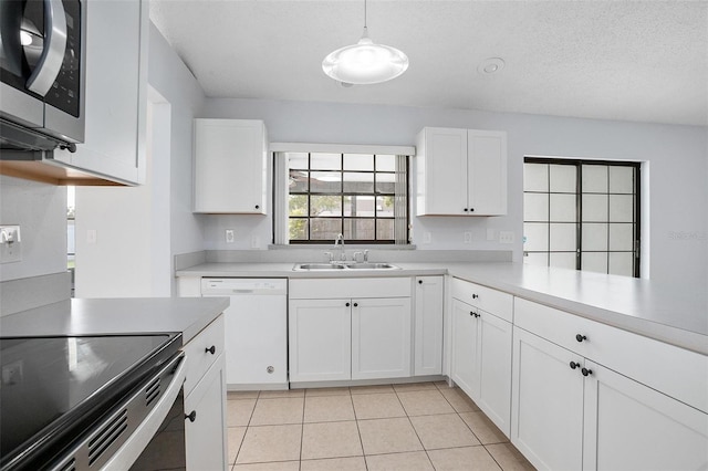 kitchen featuring white dishwasher, white cabinetry, and sink