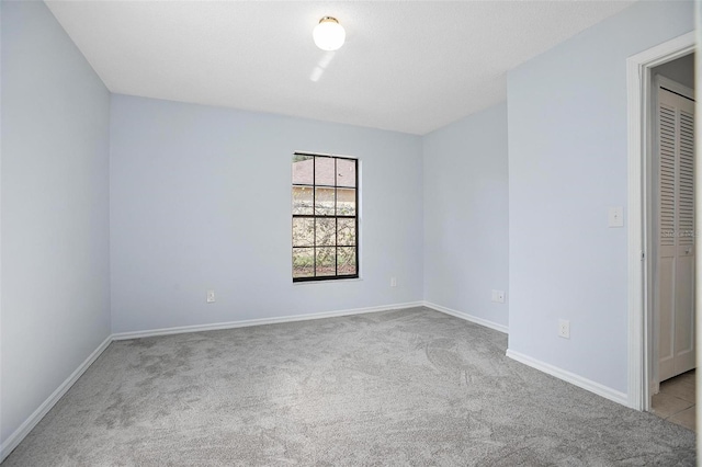 unfurnished bedroom with light carpet and a closet