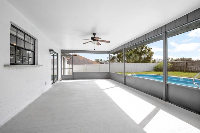 unfurnished sunroom featuring ceiling fan