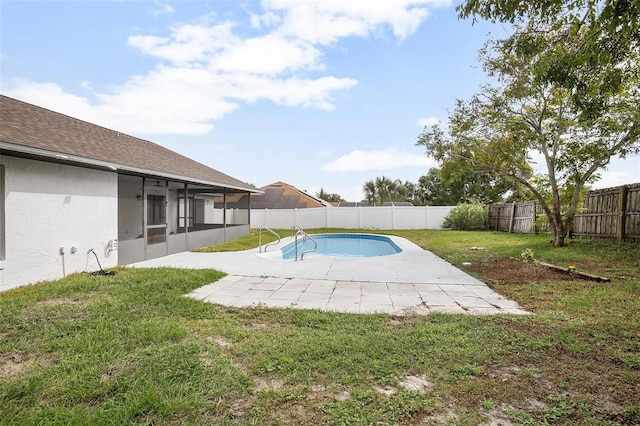 view of swimming pool with a lawn, a patio area, and a sunroom