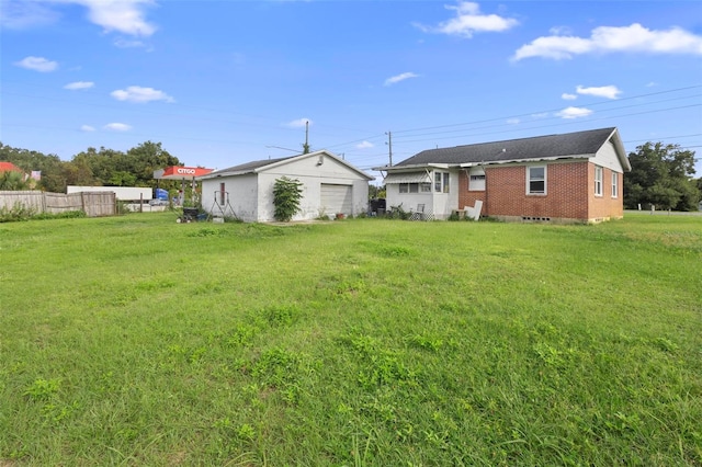 view of yard featuring a garage and an outdoor structure