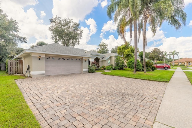 single story home featuring a garage and a front yard