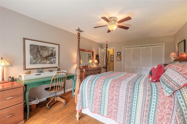 bedroom featuring built in desk, ceiling fan, a closet, and light hardwood / wood-style flooring