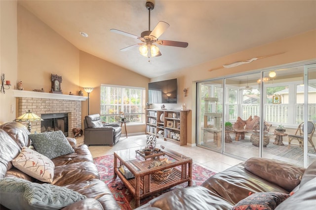 tiled living room with a brick fireplace, ceiling fan, and lofted ceiling