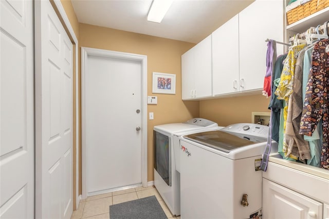 washroom featuring cabinets, independent washer and dryer, and light tile patterned floors