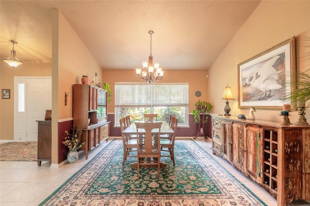 dining room with lofted ceiling, a notable chandelier, and light tile patterned flooring