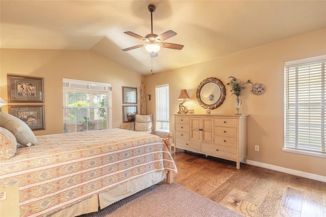 bedroom featuring multiple windows, hardwood / wood-style flooring, and ceiling fan