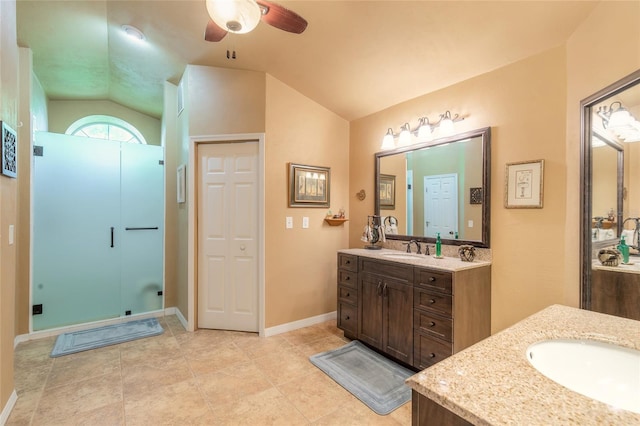 bathroom with vanity, ceiling fan, and vaulted ceiling