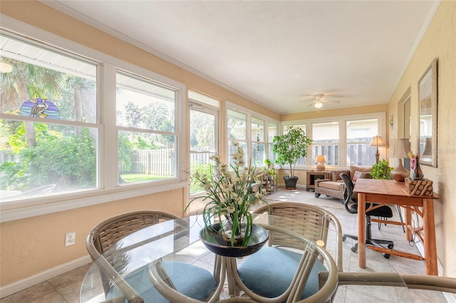 sunroom / solarium with a healthy amount of sunlight and ceiling fan