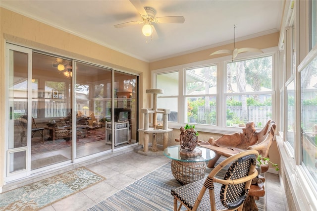 sunroom / solarium featuring ceiling fan