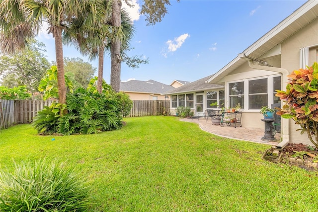 view of yard featuring a patio and a sunroom