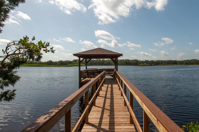 view of dock featuring a gazebo and a water view