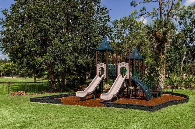 view of jungle gym featuring a lawn