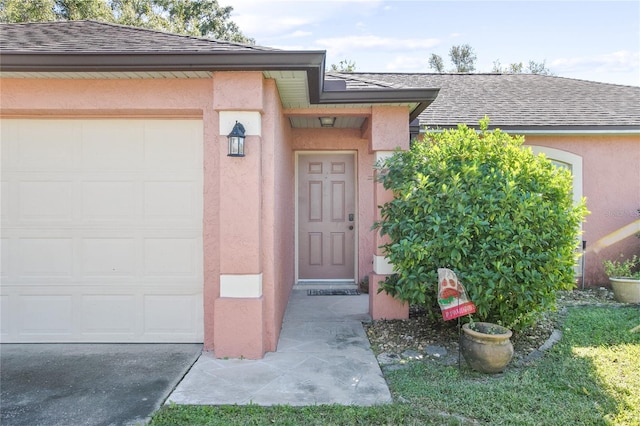 doorway to property with a garage