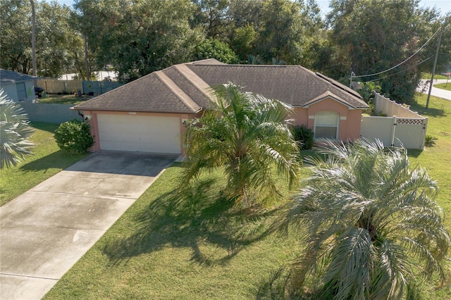 ranch-style house featuring a front lawn and a garage