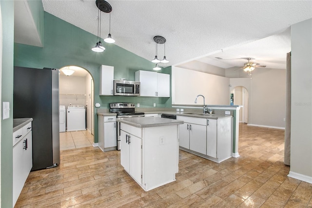 kitchen with appliances with stainless steel finishes, a center island, decorative light fixtures, and white cabinetry