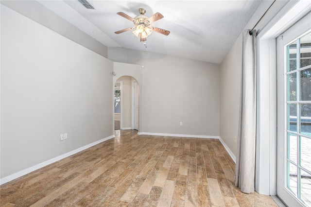 empty room featuring ceiling fan, light hardwood / wood-style floors, and a textured ceiling