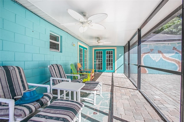 sunroom / solarium with ceiling fan and french doors