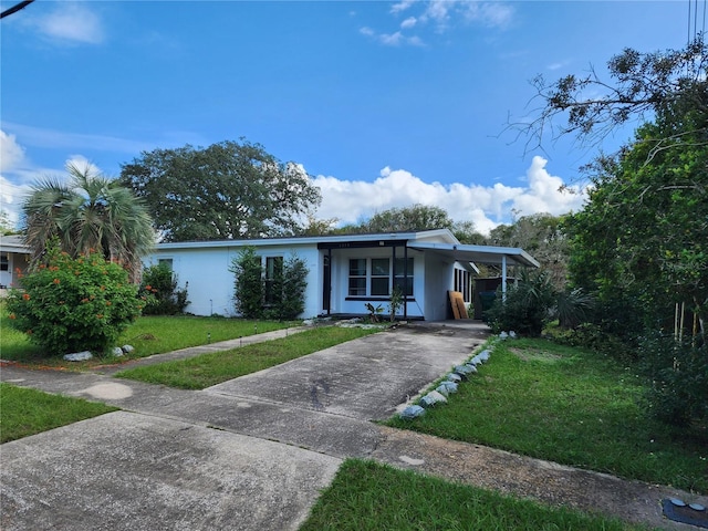 ranch-style house featuring a front yard and a carport