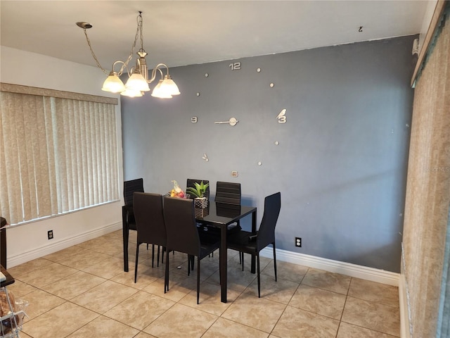 dining room featuring light tile patterned flooring and a chandelier