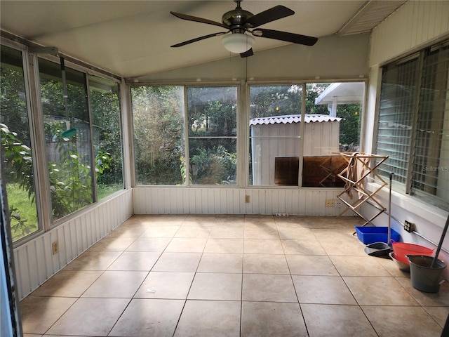 unfurnished sunroom featuring ceiling fan and vaulted ceiling