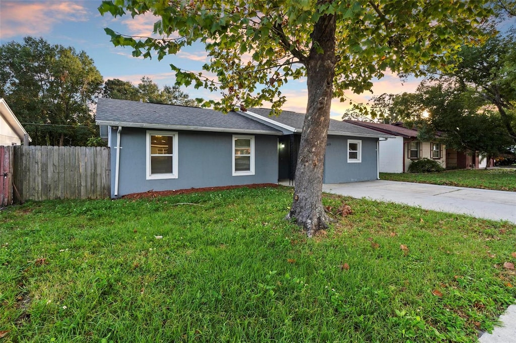 ranch-style home featuring a yard