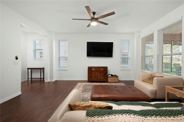 living room with dark hardwood / wood-style flooring and ceiling fan