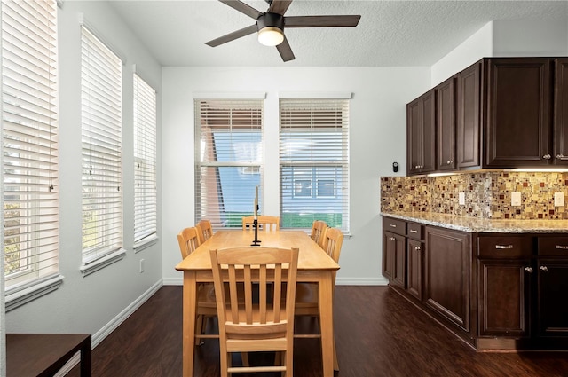 dining room featuring a textured ceiling, ceiling fan, and dark wood-type flooring