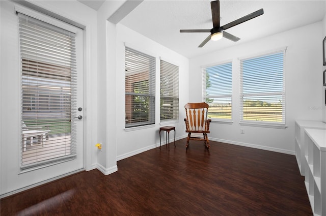 sitting room featuring ceiling fan and dark wood-type flooring