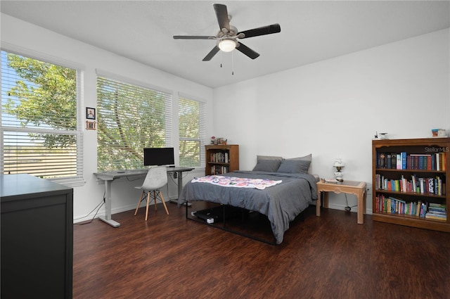 bedroom with dark hardwood / wood-style floors, multiple windows, and ceiling fan