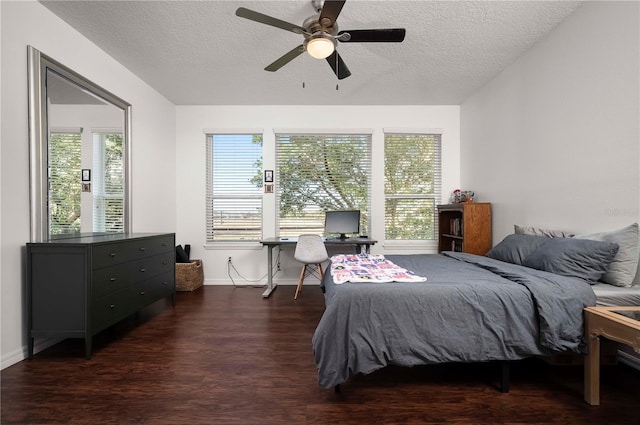 bedroom featuring ceiling fan, dark hardwood / wood-style flooring, and a textured ceiling