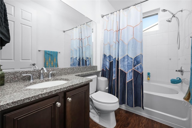 full bathroom featuring hardwood / wood-style flooring, vanity, toilet, and shower / bathtub combination with curtain