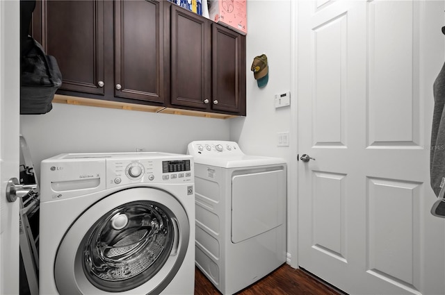 clothes washing area featuring dark hardwood / wood-style flooring, cabinets, and separate washer and dryer