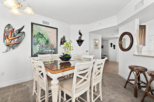 carpeted dining room featuring a textured ceiling, an inviting chandelier, and ornamental molding