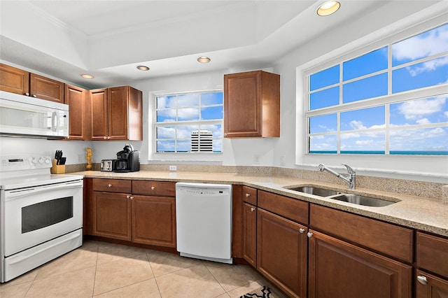 kitchen with crown molding, sink, white appliances, and light tile patterned floors