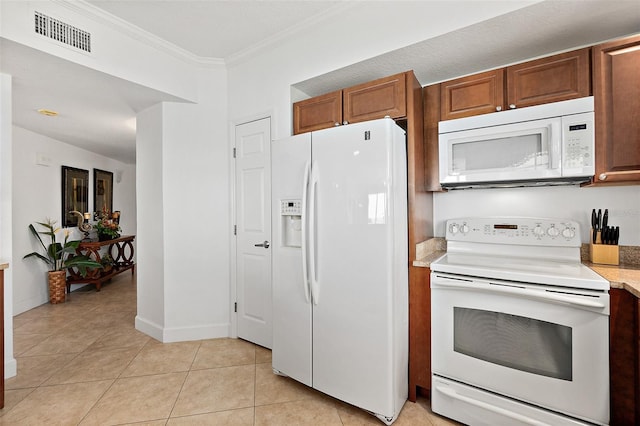 kitchen featuring ornamental molding, light tile patterned floors, and white appliances