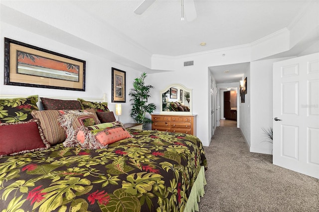 carpeted bedroom featuring ceiling fan and crown molding