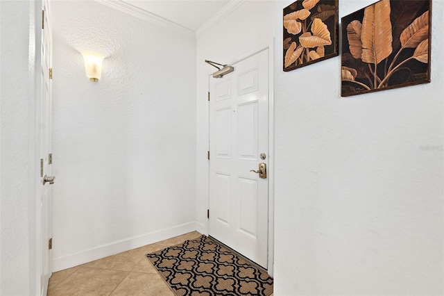 entryway with light tile patterned floors and ornamental molding