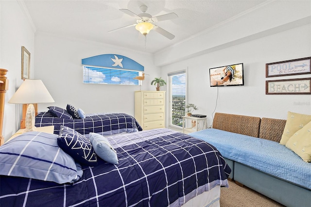 carpeted bedroom featuring ceiling fan and crown molding