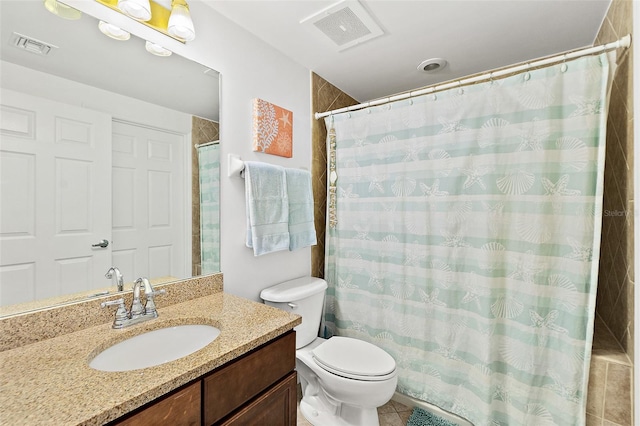 bathroom featuring vanity, tile patterned floors, and toilet