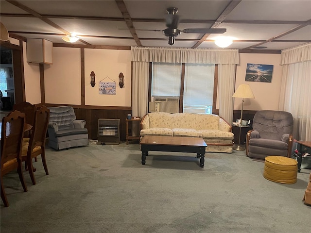 carpeted living room with ceiling fan, wood walls, and cooling unit