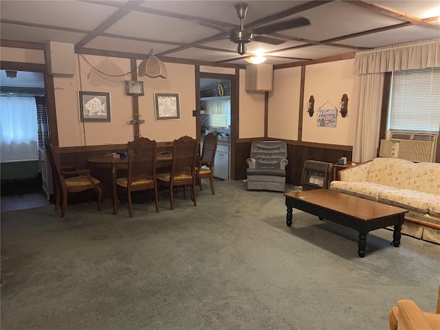 carpeted living room with wood walls