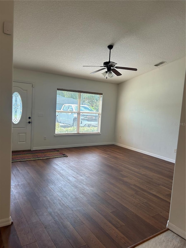 entrance foyer with a textured ceiling, dark hardwood / wood-style floors, and ceiling fan