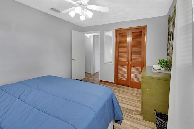 bedroom featuring a closet, ceiling fan, and light wood-type flooring