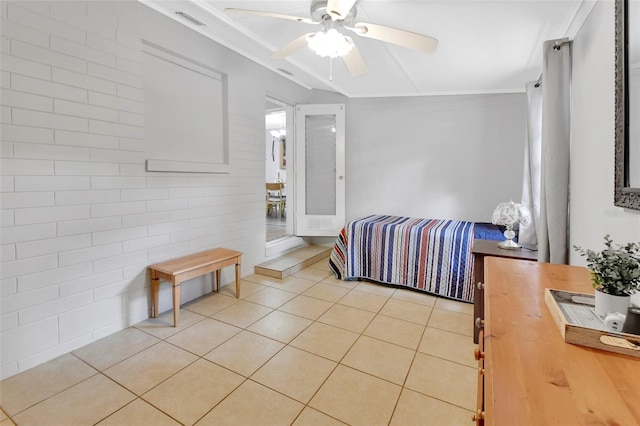 bedroom featuring crown molding, ceiling fan, and light tile patterned floors